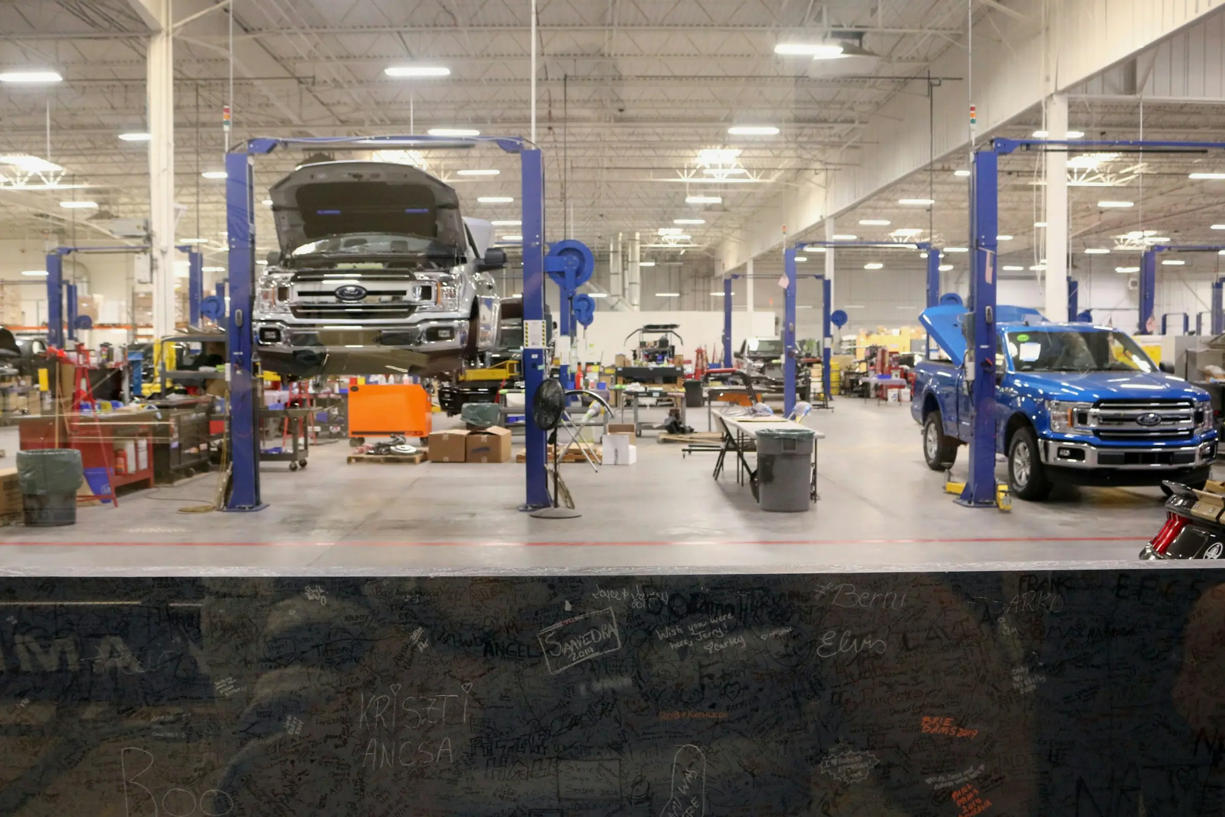 Professional auto mechanics working on vehicle repairs in Canada